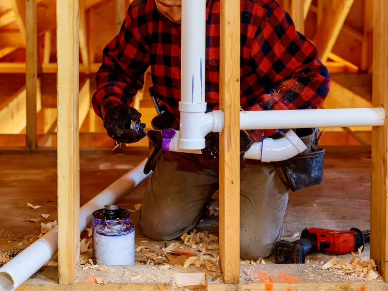 plumber applying pvc glue for residential plumbing project in zachary la